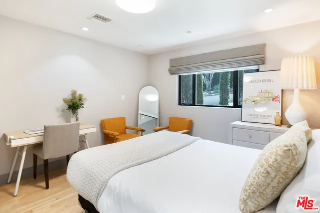 a bedroom with two beds and a table