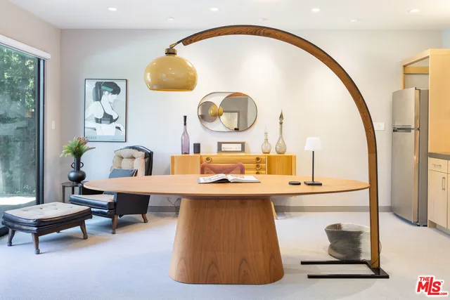 a living room with a table and chairs