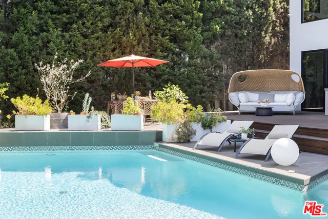 swimming pool view with a seating space