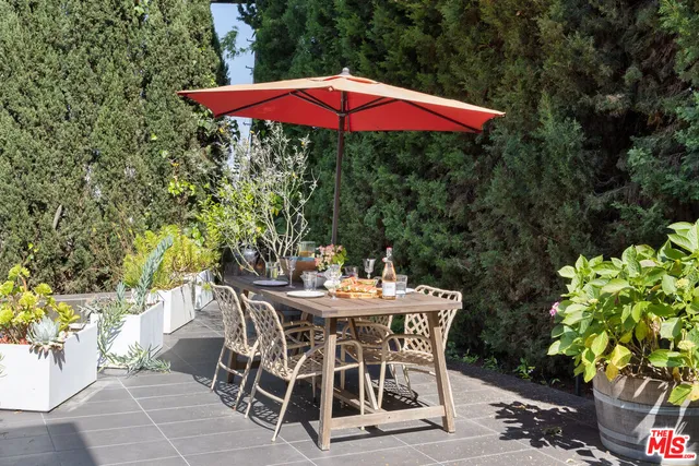 a patio with a patio table and chairs