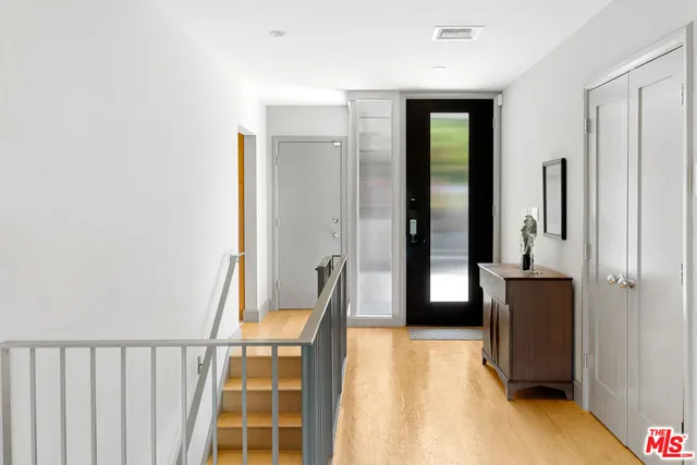 a view of a room with wooden floor and windows