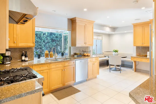a large white kitchen with a large window