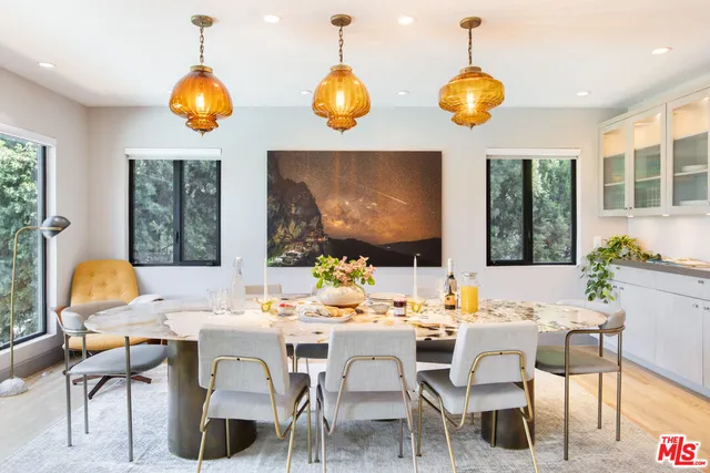 a view of a dining room with furniture and chandelier