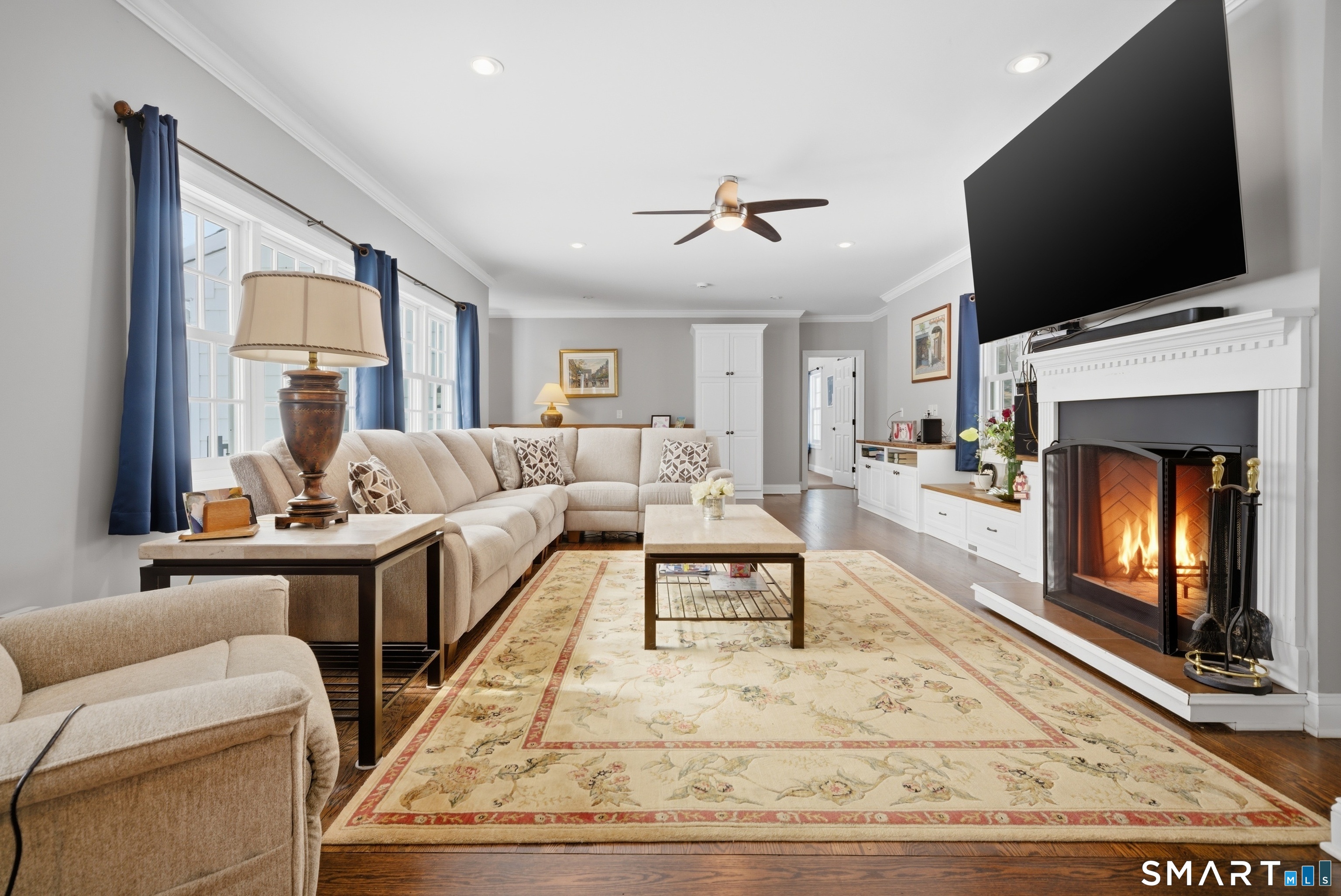 12 Dellwood Road Norwalk, CT 06850 - Photo 13 of 30 a living room with furniture a fireplace and a flat screen tv