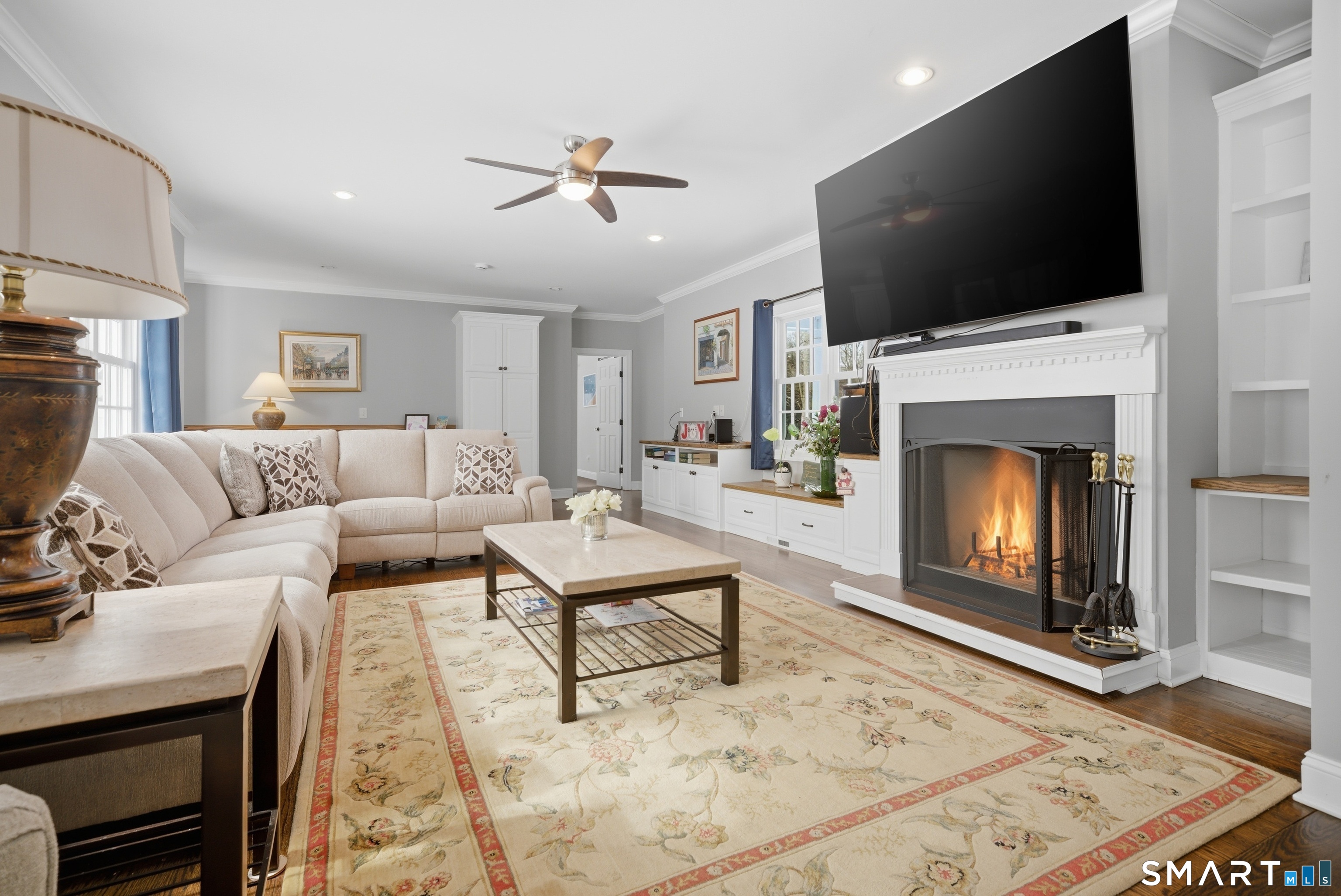 12 Dellwood Road Norwalk, CT 06850 - Photo 14 of 30 a living room with furniture a fireplace and a flat screen tv