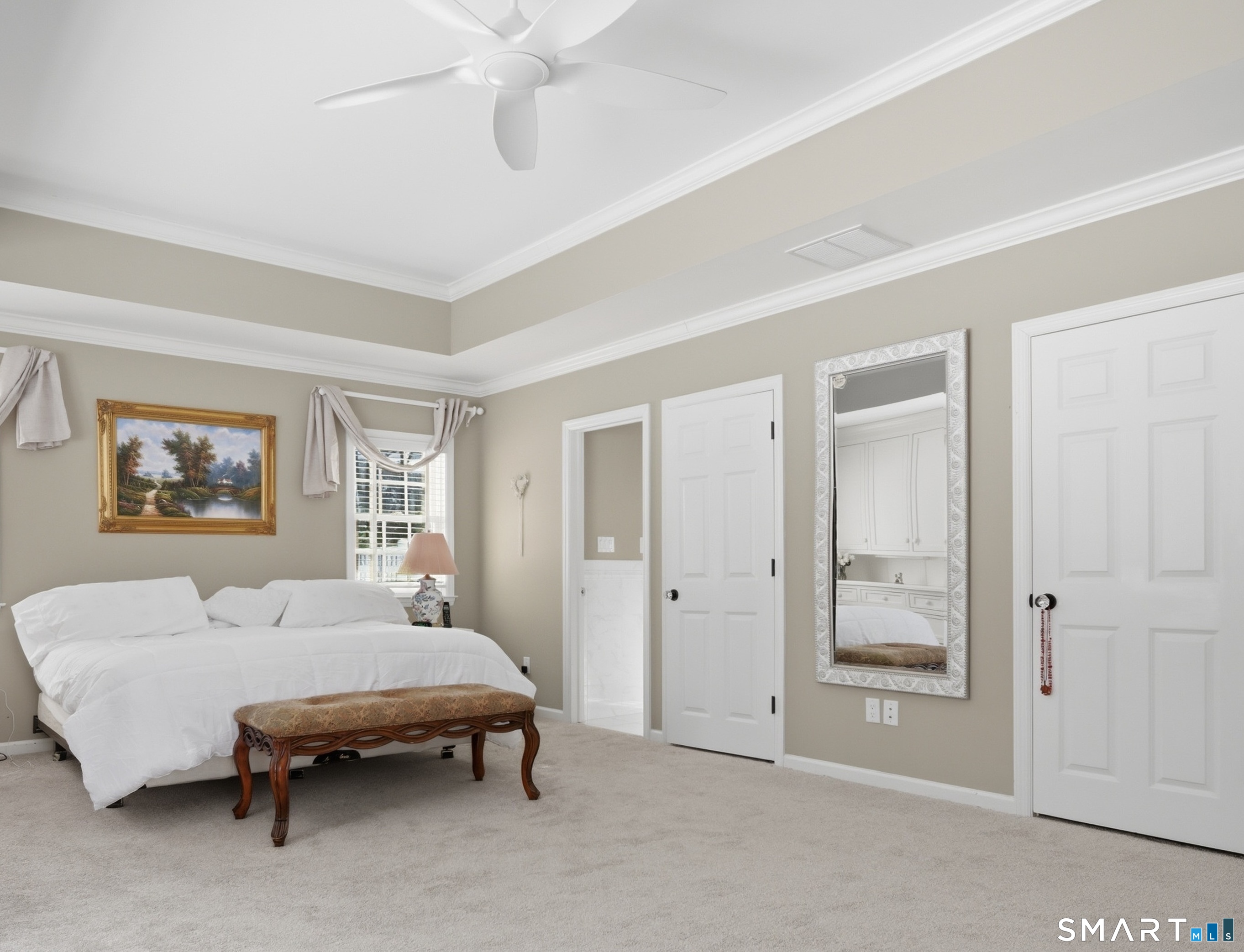 12 Dellwood Road Norwalk, CT 06850 - Photo 21 of 30 a spacious bedroom with a bed and a chandelier