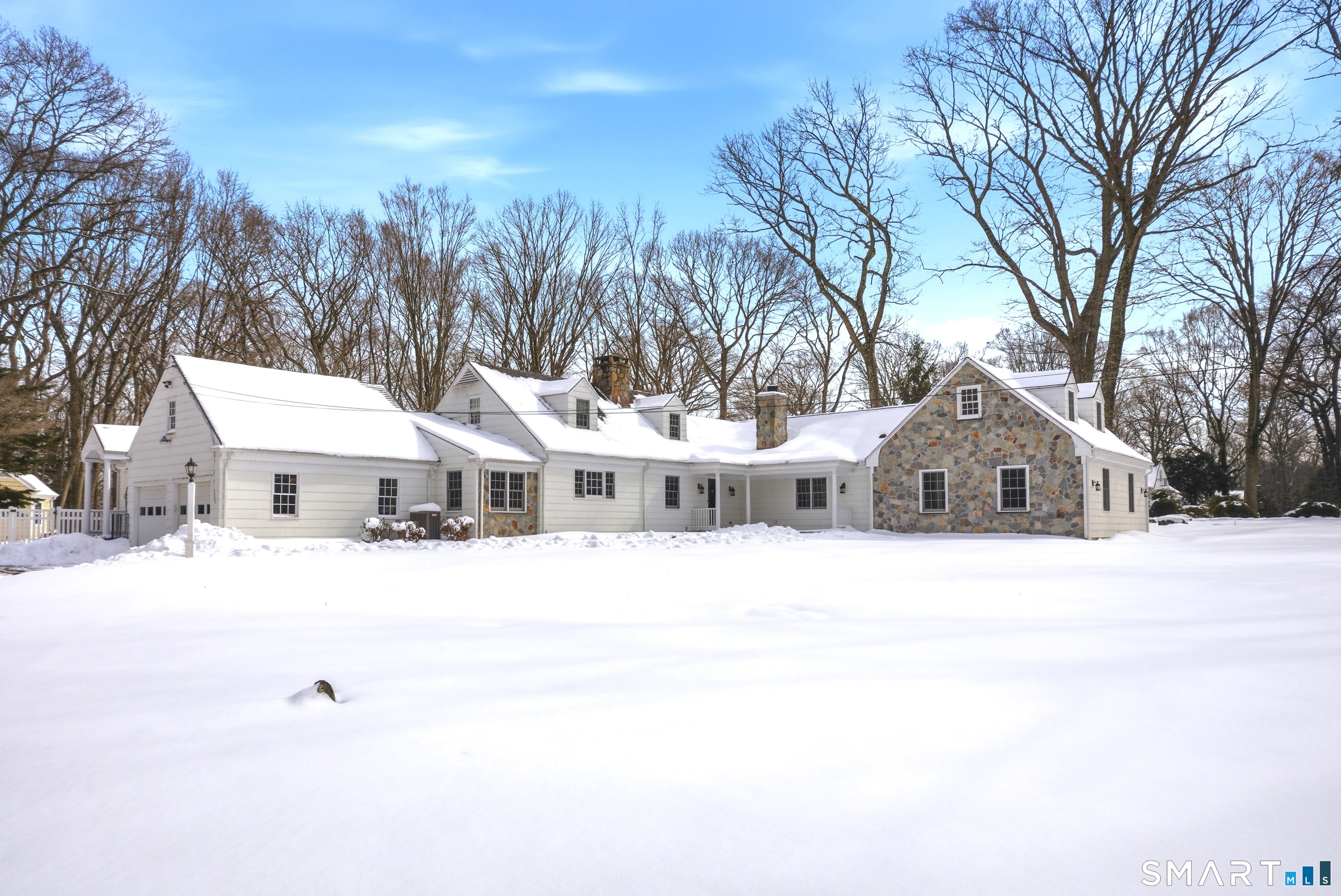 12 Dellwood Road Norwalk, CT 06850 - Photo 24 of 30 a front view of a house with a yard covered in snow