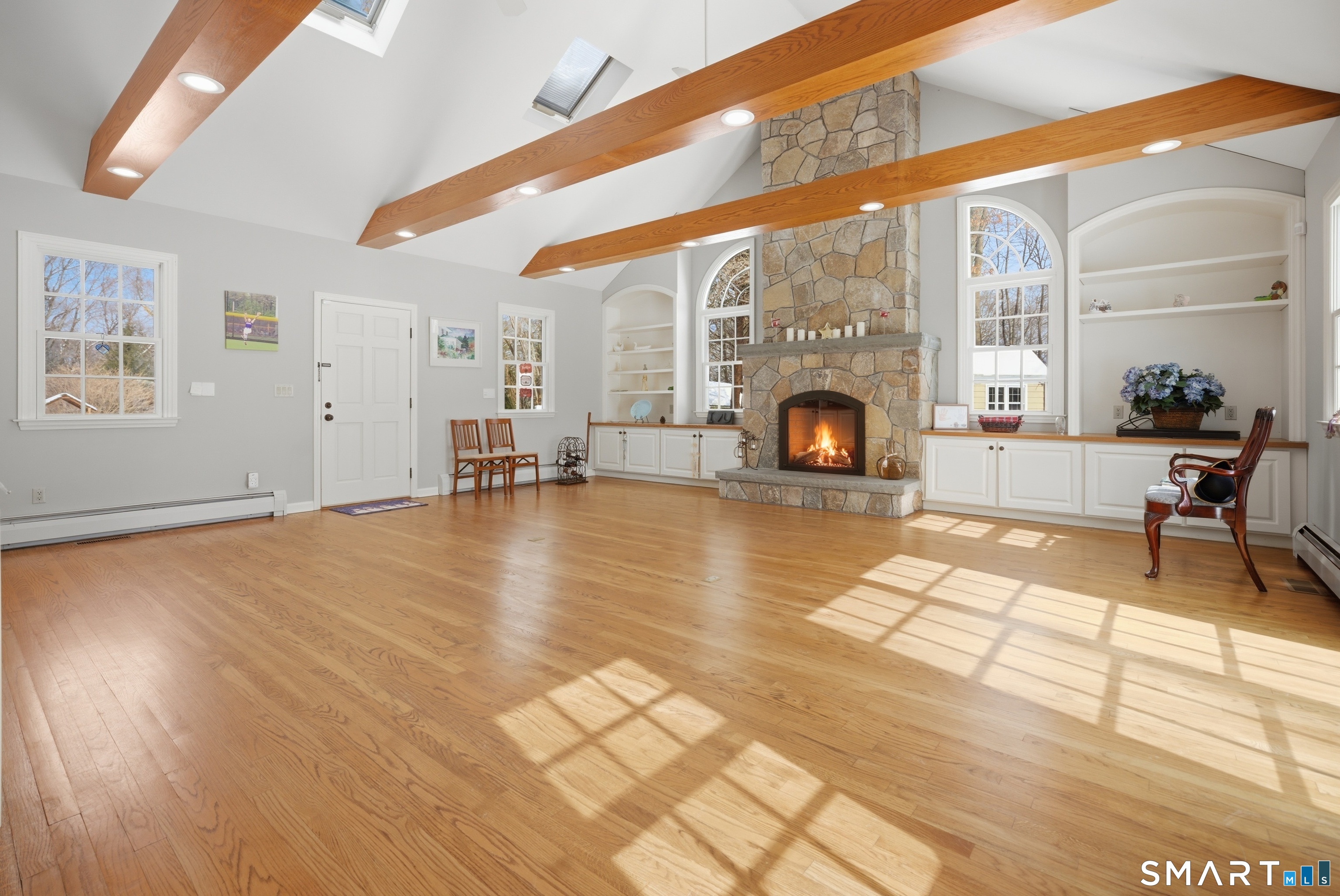 12 Dellwood Road Norwalk, CT 06850 - Photo 10 of 30 a living room with furniture a fireplace and dining table