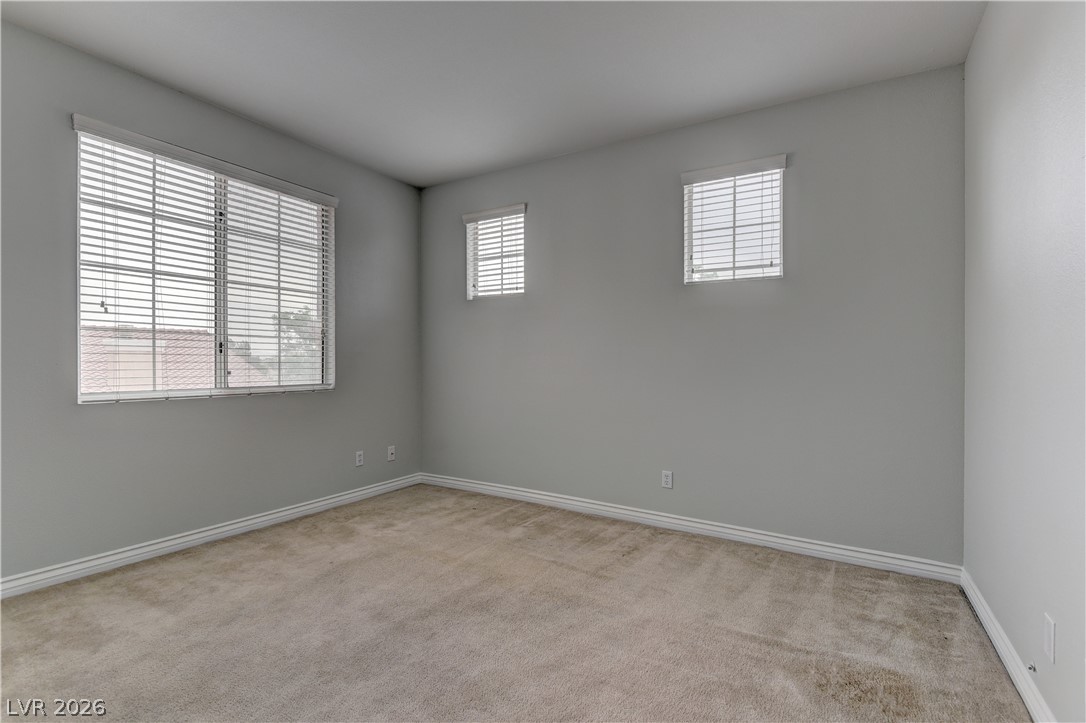 1813 Snow Spring Lane Las Vegas, NV 89134 - Photo 28 of 37 An airy bedroom with multiple windows, providing abundant natural light and a serene atmosphere.