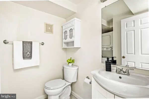 a bathroom with a sink toilet and a mirror
