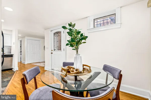 a dining room with furniture and wooden floor