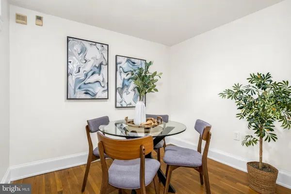 a dining room with furniture and wooden floor