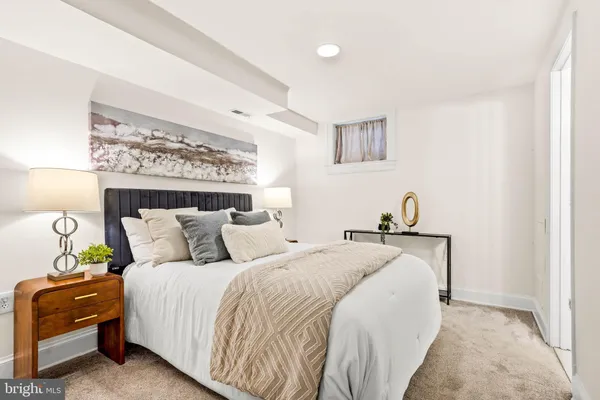 a bedroom with bed and a night stand