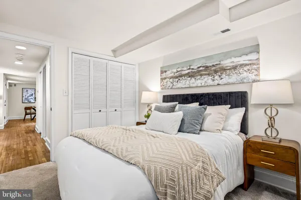 a bedroom with a bed and a mirror
