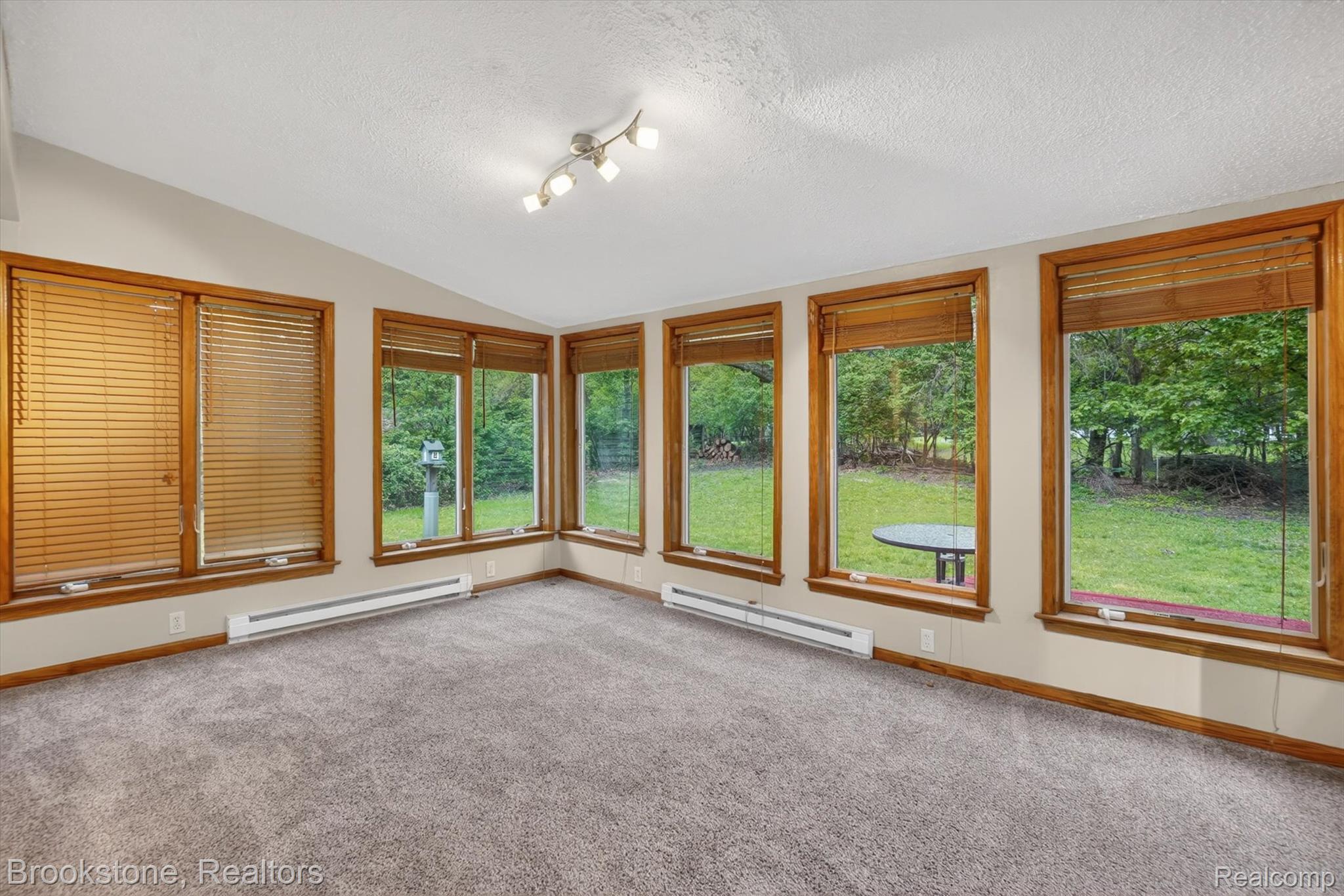 4547 Marlborough Road Okemos, MI 48864 - Photo 22 of 55 Unfurnished sunroom featuring baseboard heating and carpet flooring