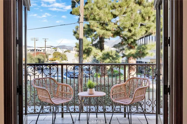 a view of a balcony with chair and wooden floor