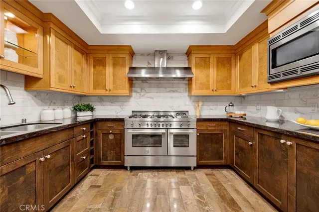 a kitchen with stainless steel appliances granite countertop a stove and a sink