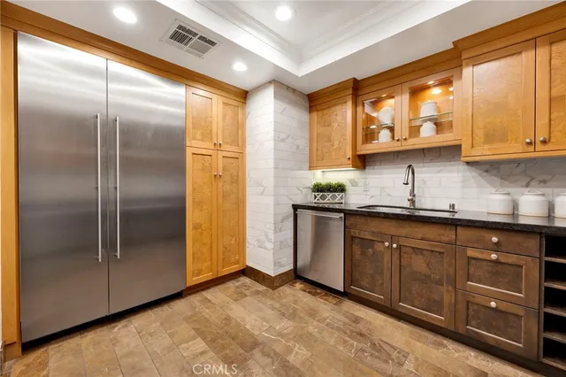 a kitchen with stainless steel appliances granite countertop a refrigerator and a sink