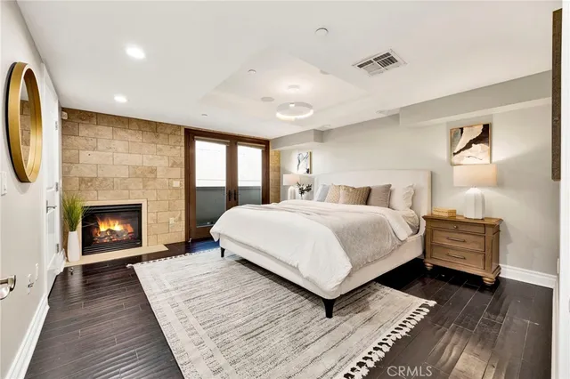 a spacious bedroom with a large bed and a fireplace