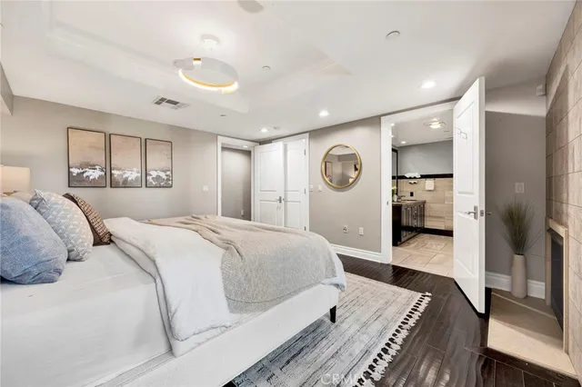 a spacious bedroom with a bed and a large mirror