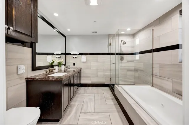 a bathroom with a granite countertop sink a toilet and bathtub