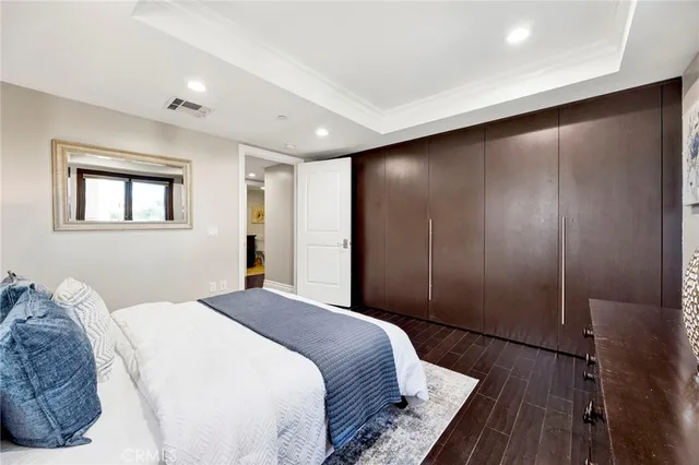 a spacious bedroom with a bed and a dresser
