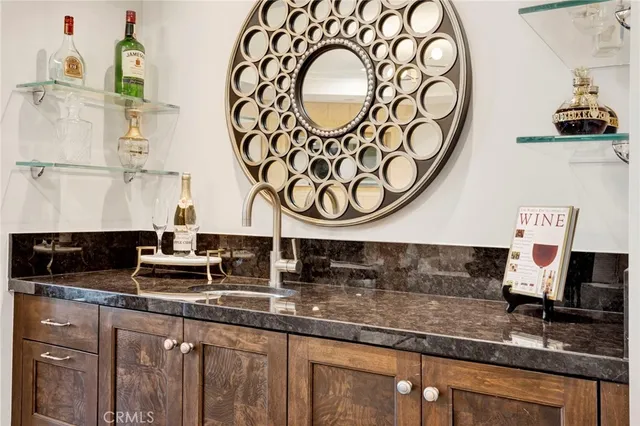 a kitchen with kitchen island granite countertop a sink and a stove