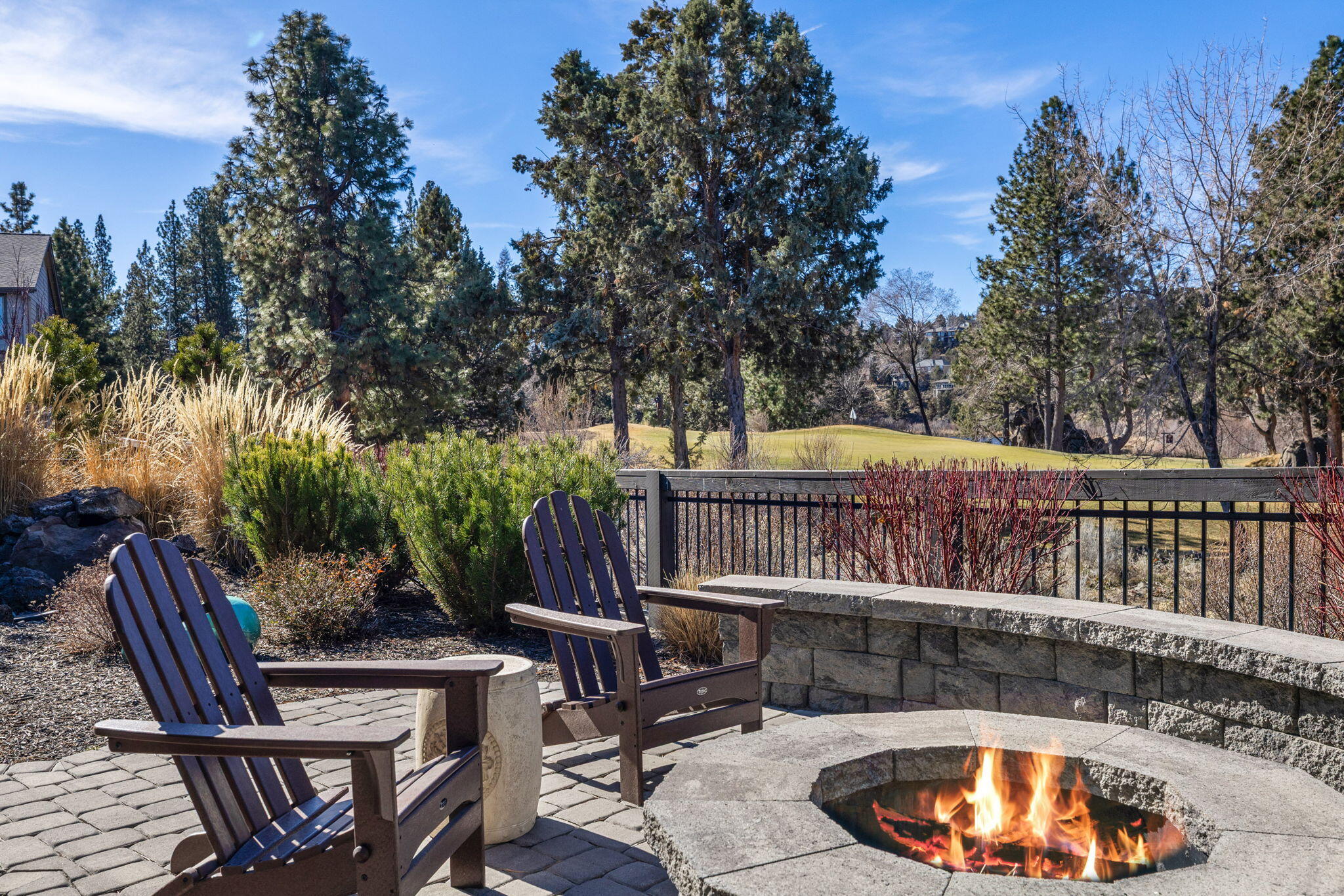 2565 Northwest Rippling River Court Bend, OR 97703 - Photo 39 of 52 fire pit and view of green