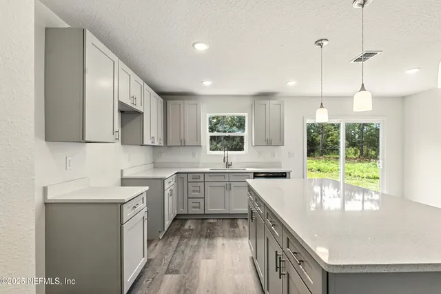 a green field with trees in the background