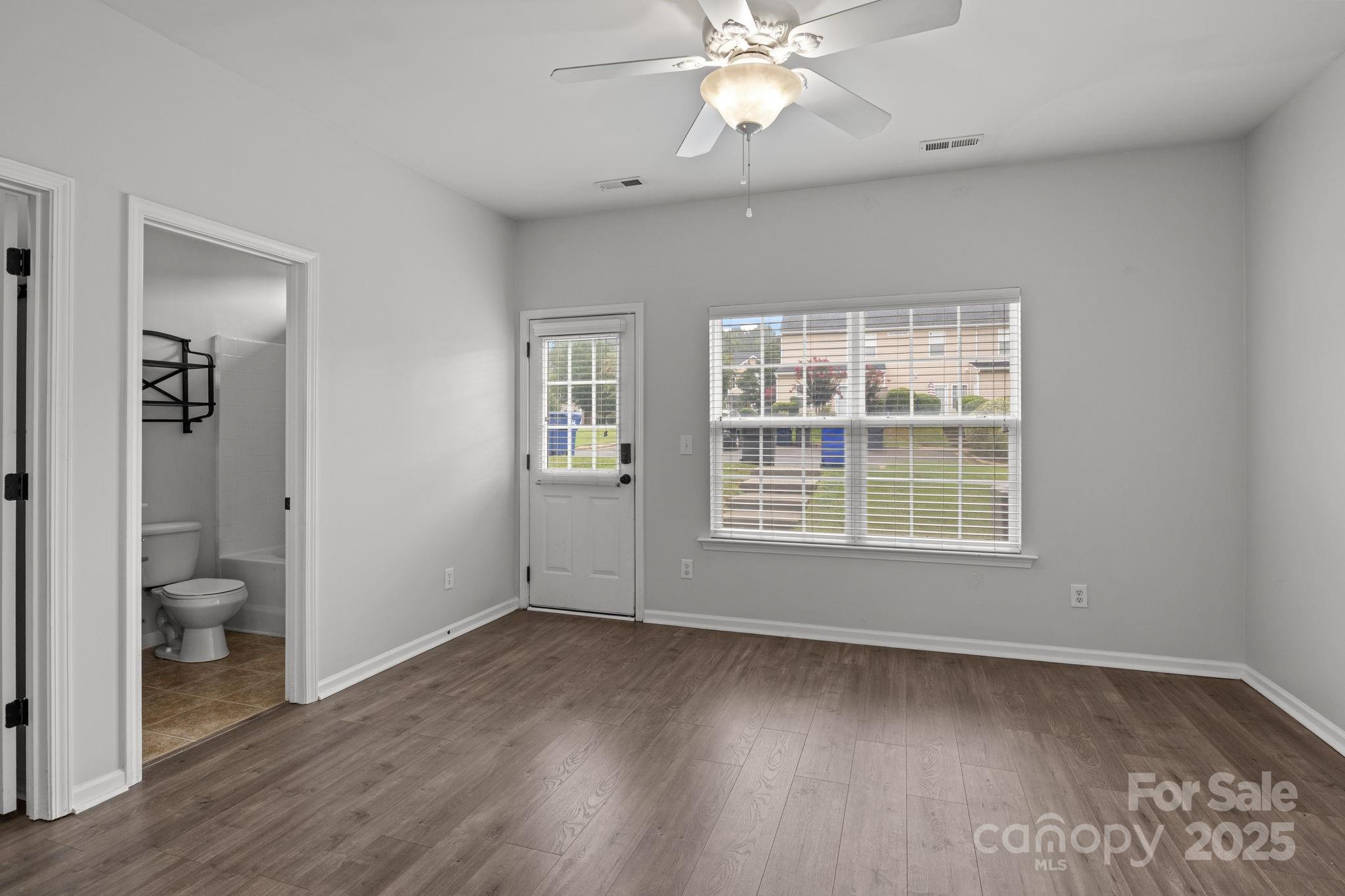 17744 Trolley Crossing Way Cornelius, NC 28031 - Photo 11 of 27 wooden floor in an empty room with a bathroom