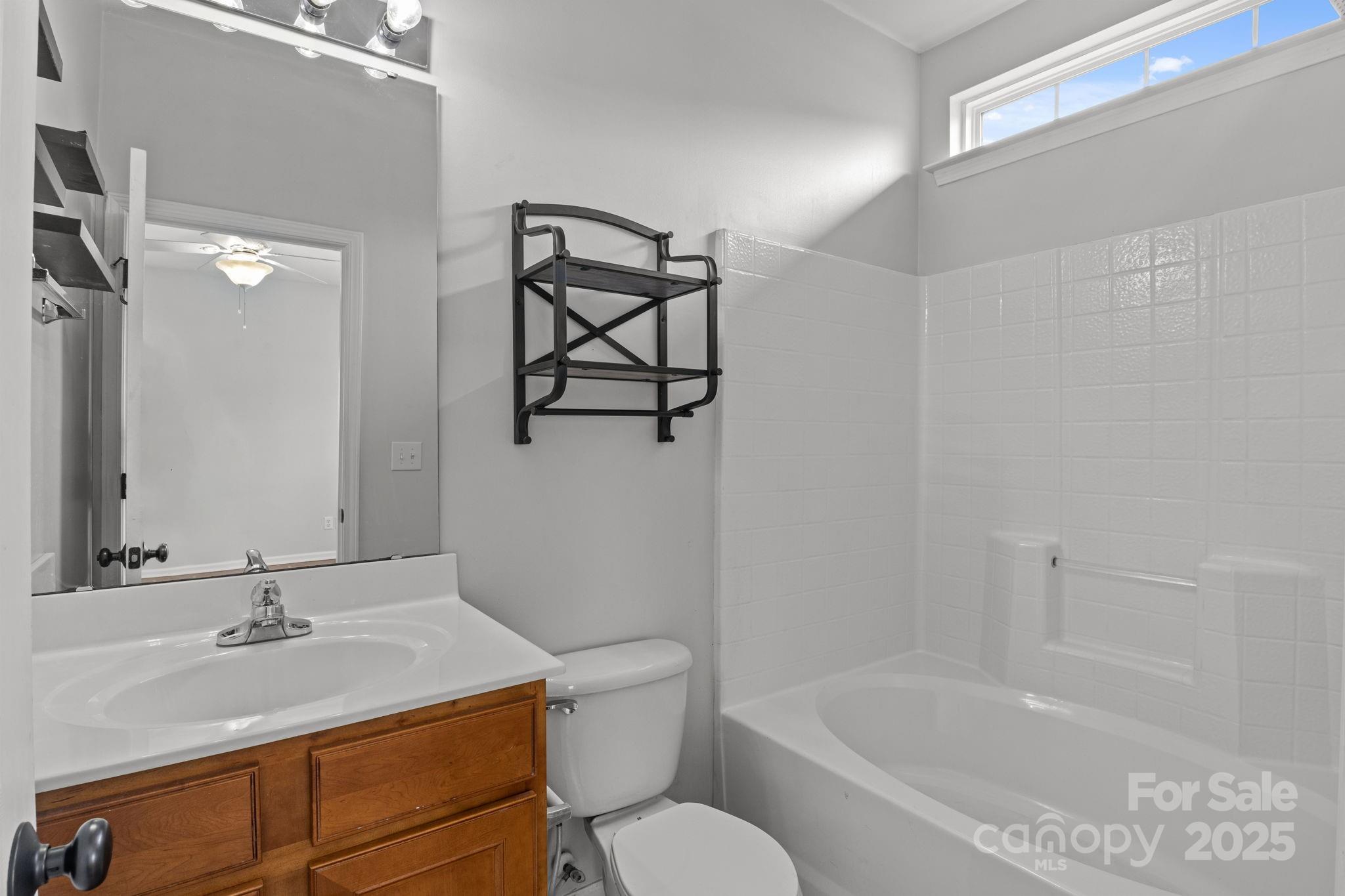 17744 Trolley Crossing Way Cornelius, NC 28031 - Photo 13 of 27 a bathroom with a sink toilet vanity and tub