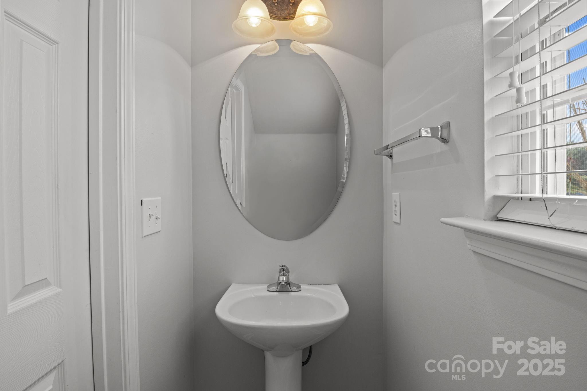 17744 Trolley Crossing Way Cornelius, NC 28031 - Photo 15 of 27 a bathroom with a sink a mirror and a toilet