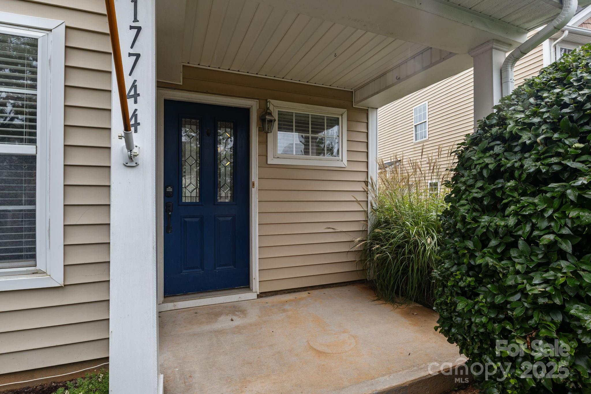 17744 Trolley Crossing Way Cornelius, NC 28031 - Photo 2 of 27 a view of small house with potted plants