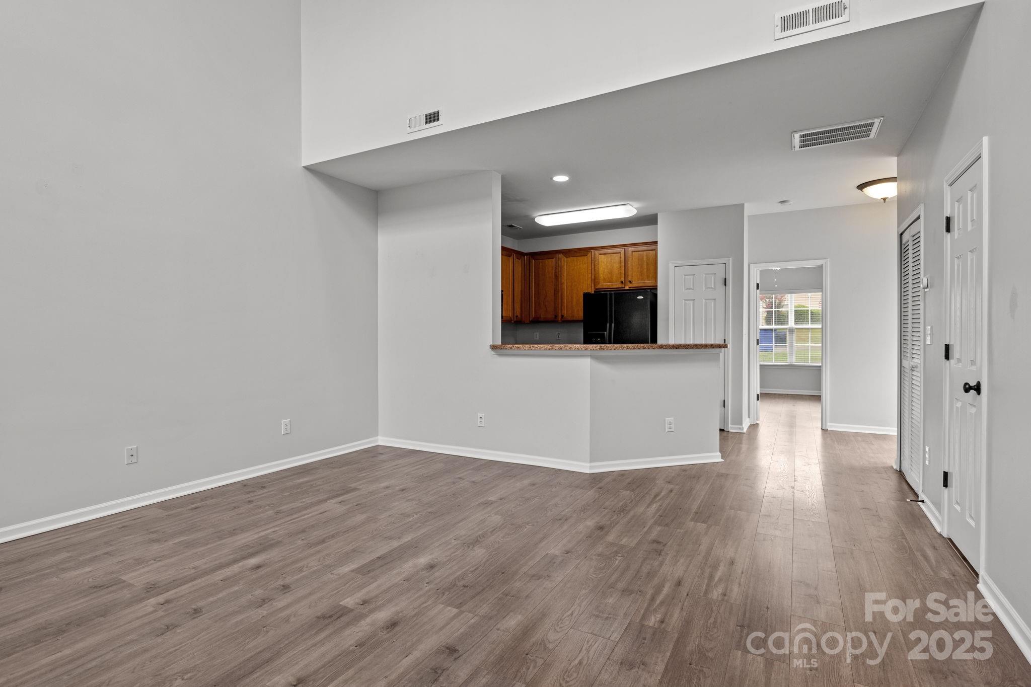 17744 Trolley Crossing Way Cornelius, NC 28031 - Photo 5 of 27 a view of a kitchen with wooden floor and a sink