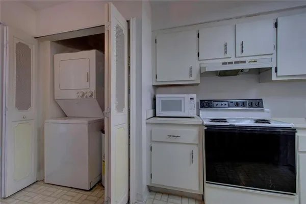 a kitchen with stainless steel appliances granite countertop a stove and a microwave