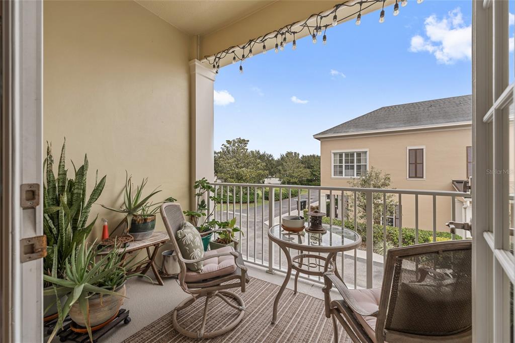 1819 Common Way Road, Unit 203 Orlando, FL 32814 - Photo 14 of 23 a balcony with furniture and a potted plant