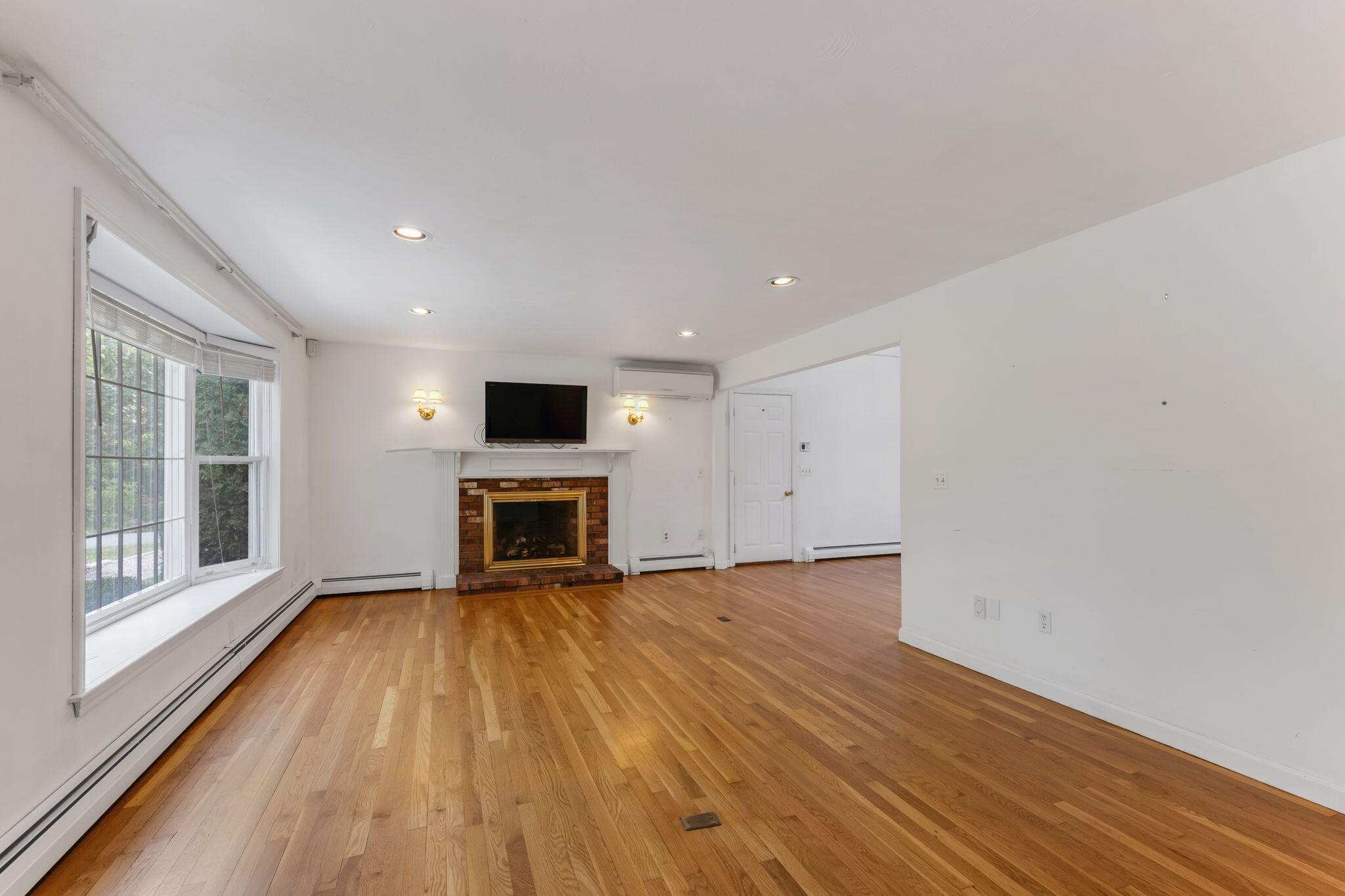 100 Potonumecot Road Chatham, MA 02633 - Photo 6 of 40 a view of an empty room with a fireplace and a window