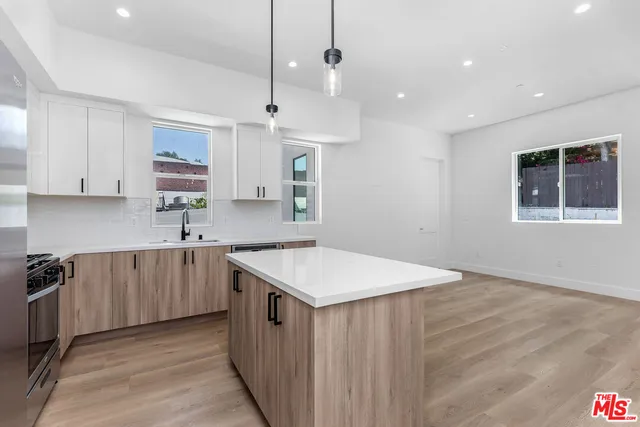 a kitchen with a stove a sink and a refrigerator