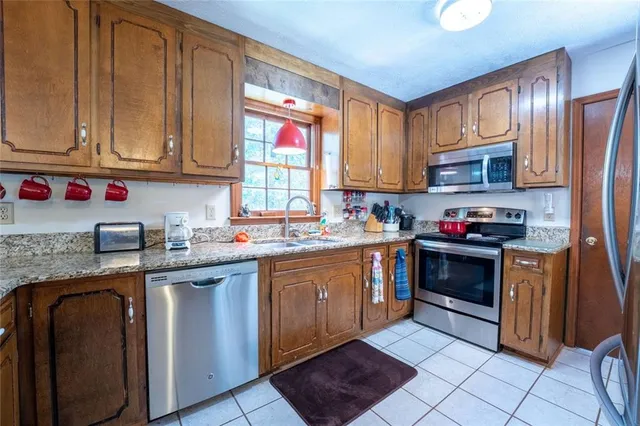 a kitchen with stainless steel appliances granite countertop a stove sink and cabinets