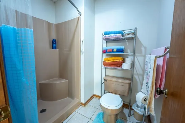 a bathroom with a toilet and a shower
