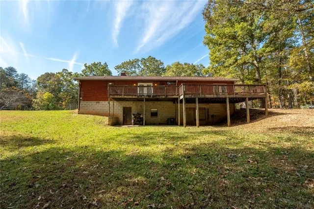 a view of a house with yard and sitting area