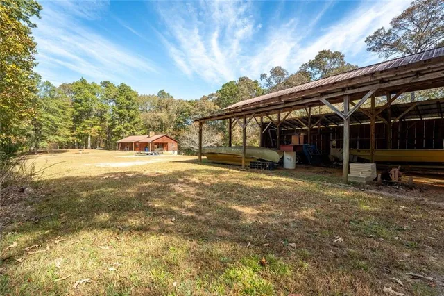 a view of a house with backyard and sitting area