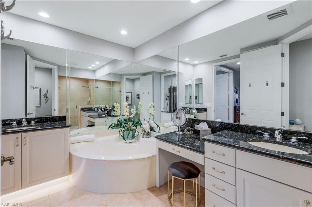 19620 Marino Lake Circle, Unit 2802 Fort Myers, FL 33913 - Photo 12 of 38 Full bathroom with a garden tub, tile patterned flooring, visible vents, a shower stall, and a sink