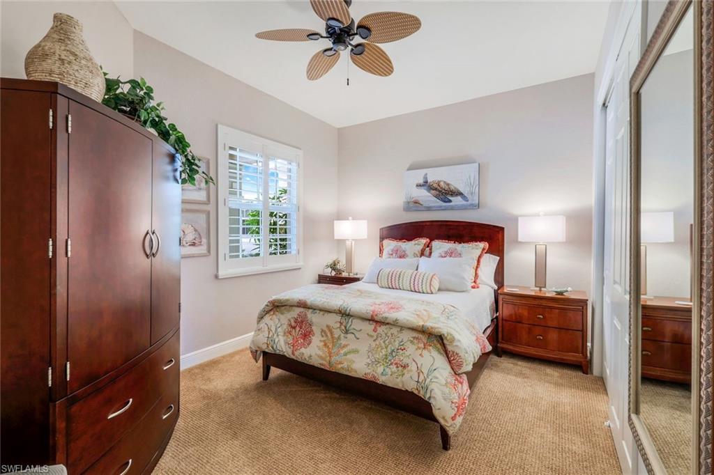 19620 Marino Lake Circle, Unit 2802 Fort Myers, FL 33913 - Photo 15 of 38 Bedroom featuring baseboards, light carpet, and a ceiling fan