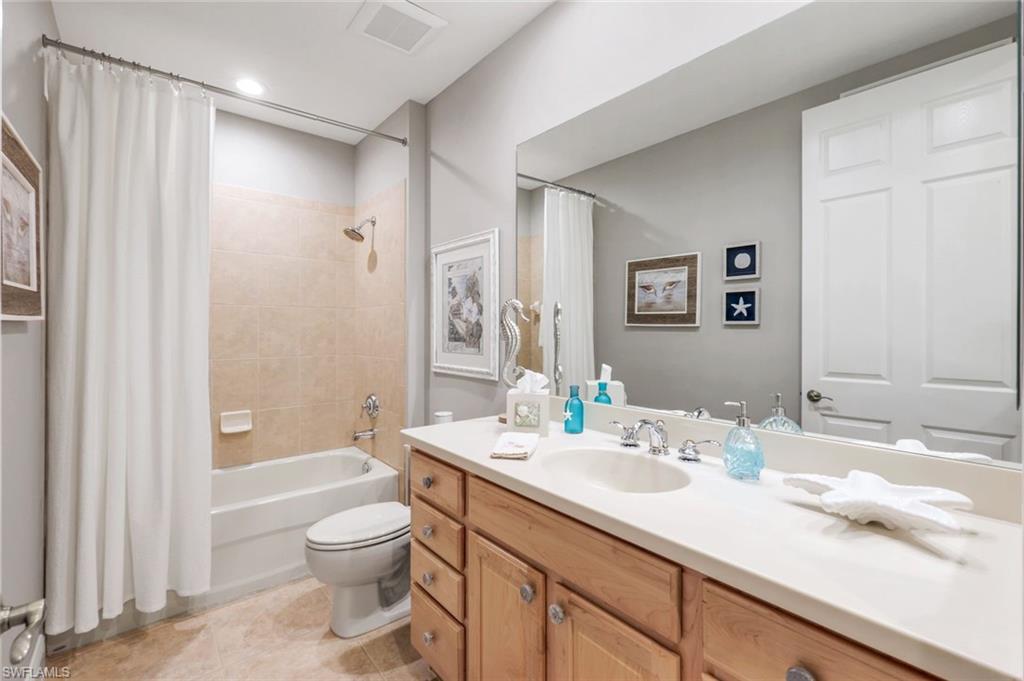 19620 Marino Lake Circle, Unit 2802 Fort Myers, FL 33913 - Photo 16 of 38 Private guest bath Full bath featuring visible vents, shower / bath combo, vanity, tile patterned floors, and toilet