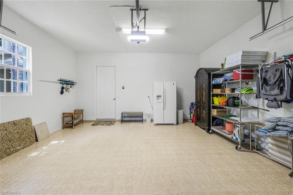 19620 Marino Lake Circle, Unit 2802 Fort Myers, FL 33913 - Photo 28 of 38 Garage featuring white fridge with ice dispenser