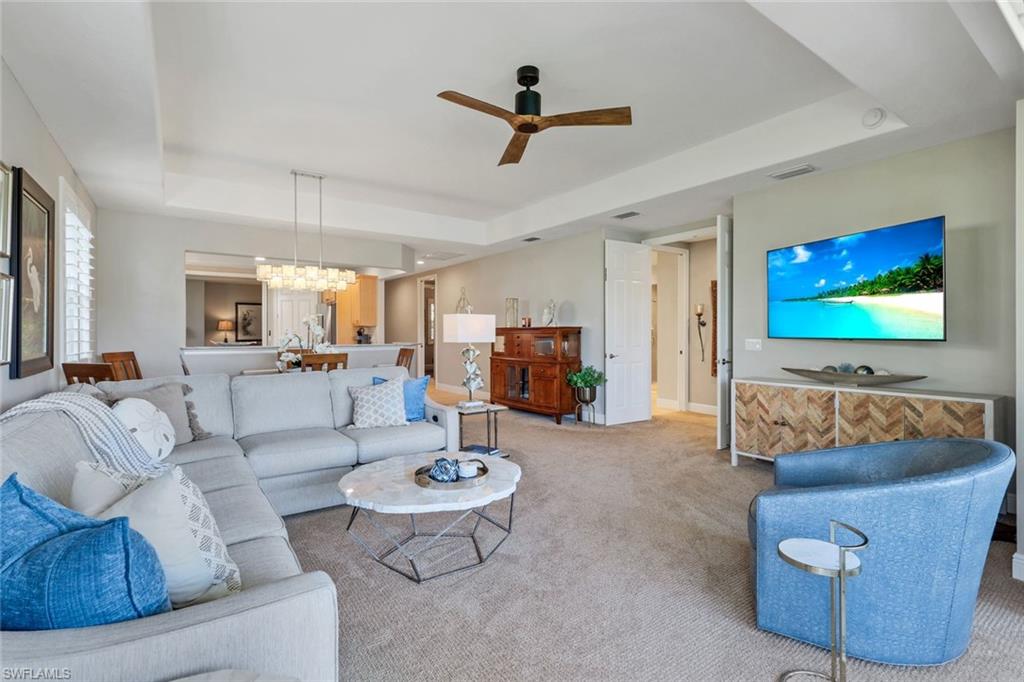 19620 Marino Lake Circle, Unit 2802 Fort Myers, FL 33913 - Photo 8 of 38 luxuriously Carpeted and Furnished living room with raised ceiling, and ceiling fan