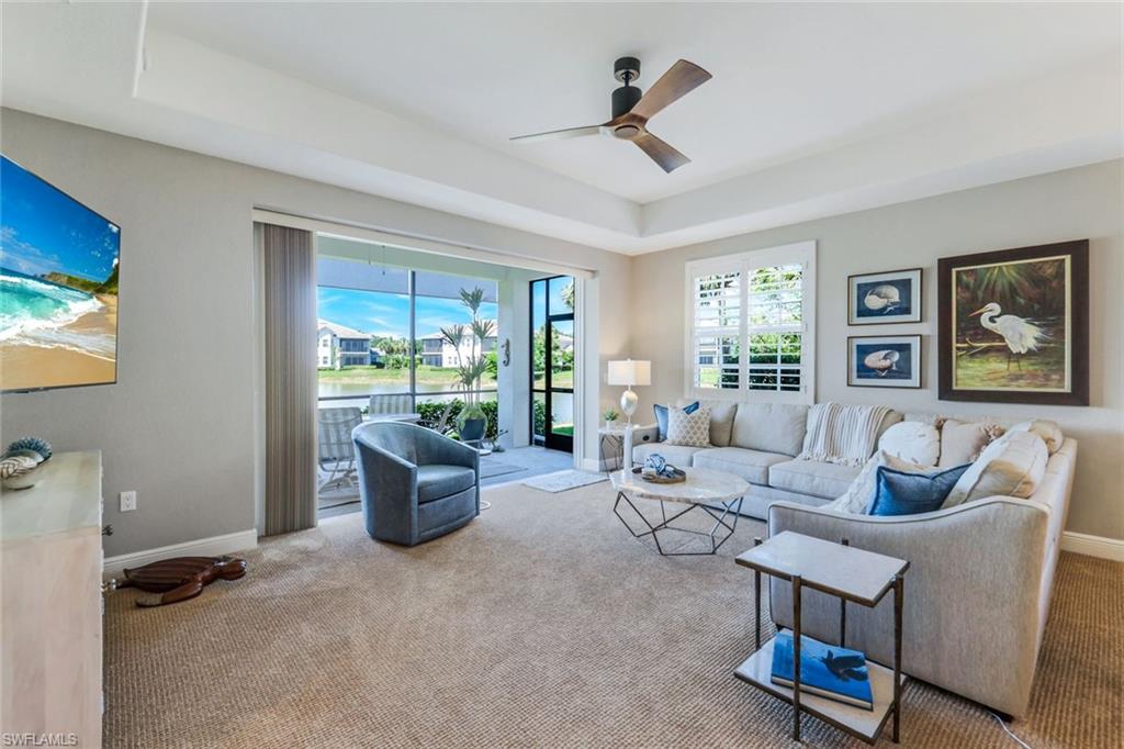 19620 Marino Lake Circle, Unit 2802 Fort Myers, FL 33913 - Photo 9 of 38 Carpeted living room with tray ceiling