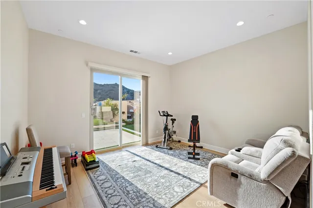 a bedroom with a bed and a flat tv screen on a dresser