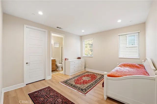 a spacious bedroom with a bed and a couch